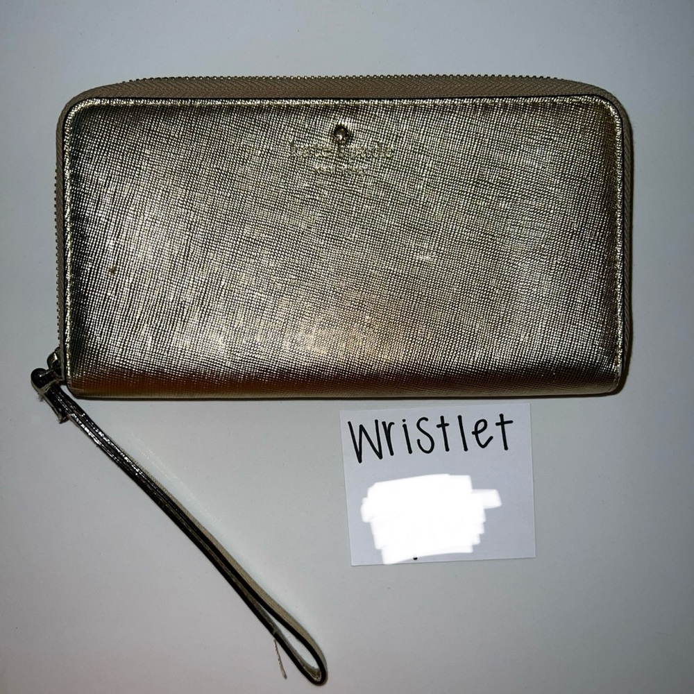 Gold Kate Spade wristlet for sale. Used condition - small blemish.